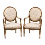 A pair of carved and giltwood fauteuils in Louis XVI taste, early 20th century,