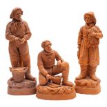 A group of three French terracotta figures of fishermen: the bases incised 'Pecheur' and signed