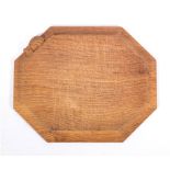 Workshop of Robert 'Mouseman' Thompson (Kilburn), an English oak bread board,: of octagonal form,