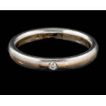 An 18 carat gold and platinum diamond ring,: the brilliant cut diamond set into the polished band,