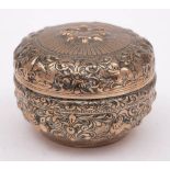 An Indian silver circular box and cover: with embossed animal and foliate decoration, 9.