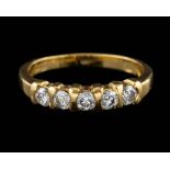 An 18 carat gold and diamond ring,: set with five brilliant cut diamonds, approximately 0.