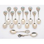 A matched set of ten silver and enamel teaspoons, various makers and dates: initialled,