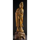 A large Chinese carved soapstone figure of Guanyin: her hair in a high chignon,