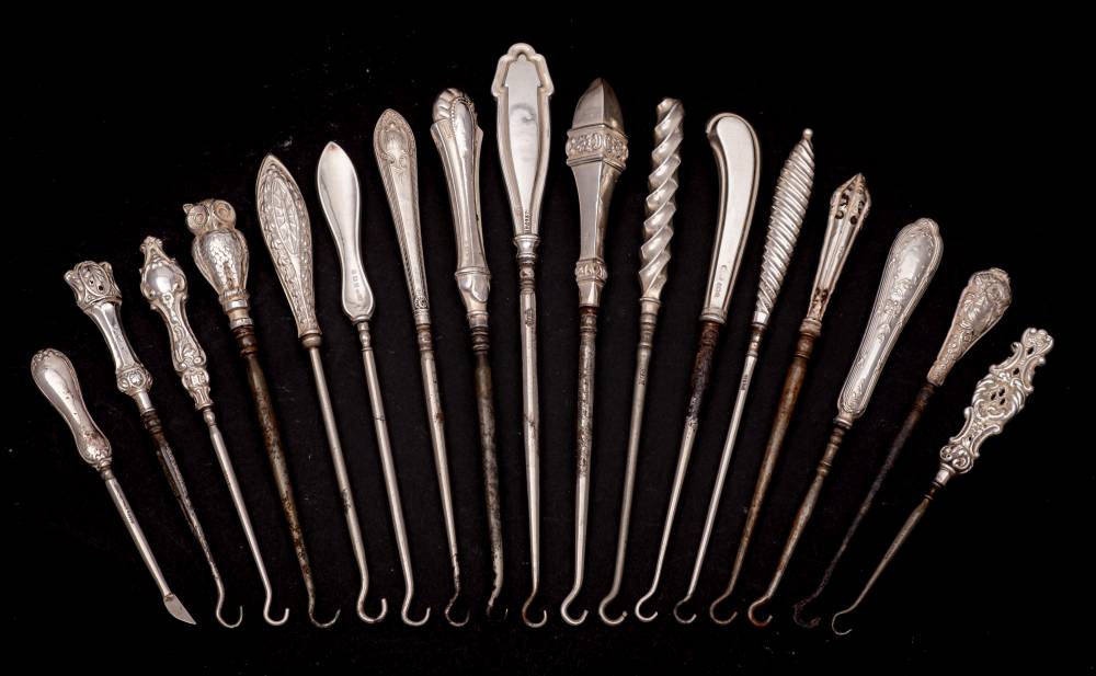 A collection of fifteen assorted small silver-handled button hooks,