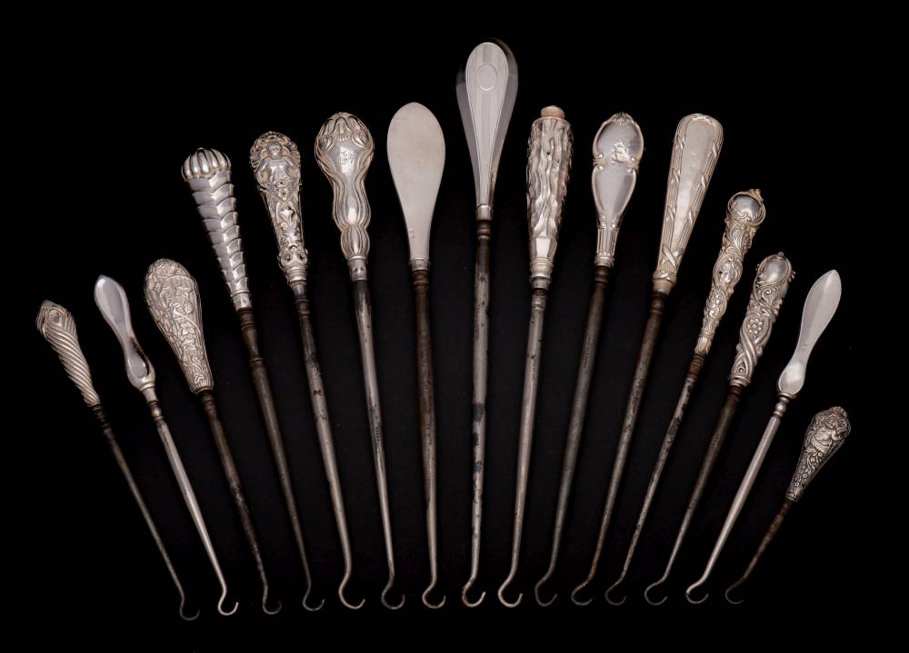 A collection of fifteen assorted silver-handled button hooks,