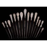 A collection of fifteen assorted silver-handled button hooks,