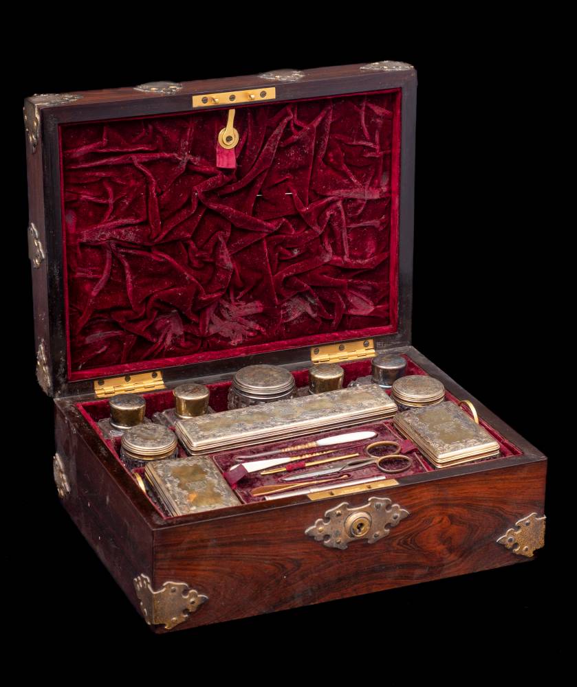 A Victorian rosewood and brass mounted travelling vanity case: the hinged lid enclosing a fitted