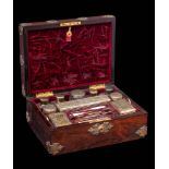 A Victorian rosewood and brass mounted travelling vanity case: the hinged lid enclosing a fitted