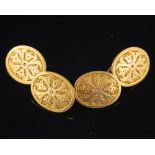 A pair of double sided cufflinks,: the oval panels with engraved detail, stamped 15, 2.2cm long, 6.