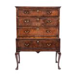 A George II walnut and crossbanded chest on stand, mid 18th century and later,