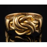 An 18 carat gold knot ring,: stamped 18 with full Birmingham hallmarks, ring size O 1/2, 6.7g.