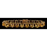A 9 carat gold citrine bracelet,: set with oval cut citrines, to a pierced clasp,