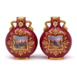 A pair of Coalport ruby ground porcelain moon flasks: of small size with gilt scroll handles,