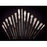 A collection of fifteen assorted silver-handled button hooks,