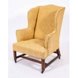 A George III mahogany and upholstered wing back armchair, circa 1770,: with 'camel back',