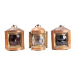 A set of three copper ships' lanterns: unsigned, comprising port, starboard and toplight,