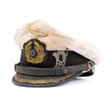 A WWII Kriegsmarine U-Boat Officer's peaked cap: the white cloth cover with gilt brass eagle and