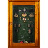 A framed display of various Naval and yacht club cap badges: including 'Royal Alfred Yacht Club',