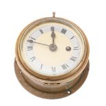 A brass bulkhead clock by Astral: with silvered chapter ring and Roman numerals,