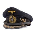 A WWII Kriegsmarine U-Boat Officers peaked cap: the black cloth cap with gilt embroidered badges,