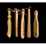 A set of five 19th century carved bone teethers: one in the form of a scimitar,