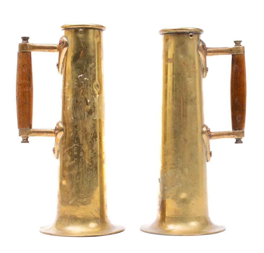 A pair of late19th/early 20th century brass salination jugs: with wooden handles, 30cm high.
