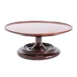 A mahogany Lazy Susan constructed from timber taken from HMS Britannia: the circular top with