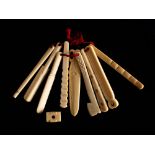 A set of nine 19th century bone teethers: in the from of tools and a cricket bat,