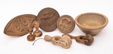 Two treen butter rollers:, a circular butter mould with urn and floral stem, 16cm diameter,