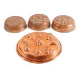 A circular copper mould: with raised decoration of shells, 28cm diameter,