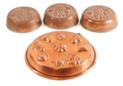 A circular copper mould: with raised decoration of shells, 28cm diameter,