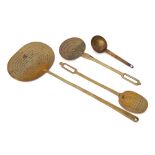 A 19th Century brass oval long handled skimmer:, a smaller oval skimmer and one other,