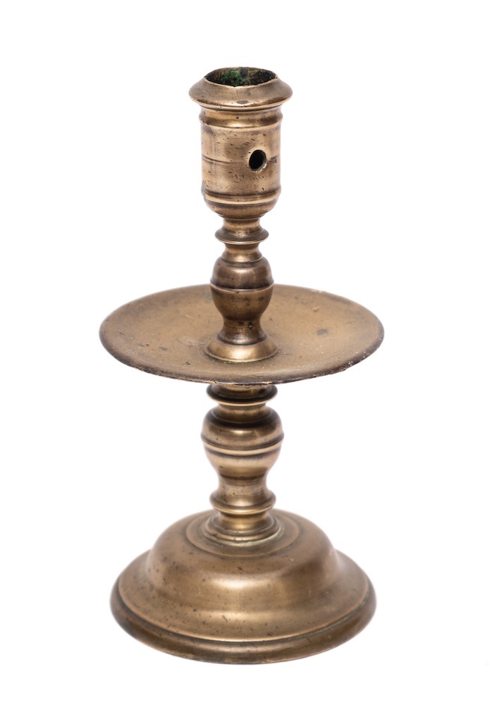 A mid 17th Century Dutch cast brass 'Heemskirk' candlestick: with turned stem,