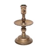 A mid 17th Century Dutch cast brass 'Heemskirk' candlestick: with turned stem,