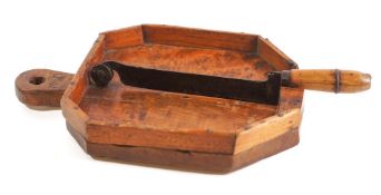 A 19th Century Continental bread chopping board: of octagonal shape, initialled thrice 'M.M.