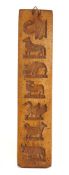 A rectangular fruitwood biscuit mould: with seven bird and animal impressions to one side and