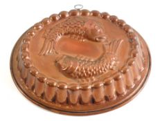 An oval tinned copper pie mould:, decorated with two fish, having reeded border, 34 x 28cm.