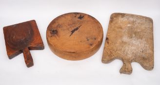A circular wood weight for a cheese press:, 40cm diameter, also two wooden chopping boards.