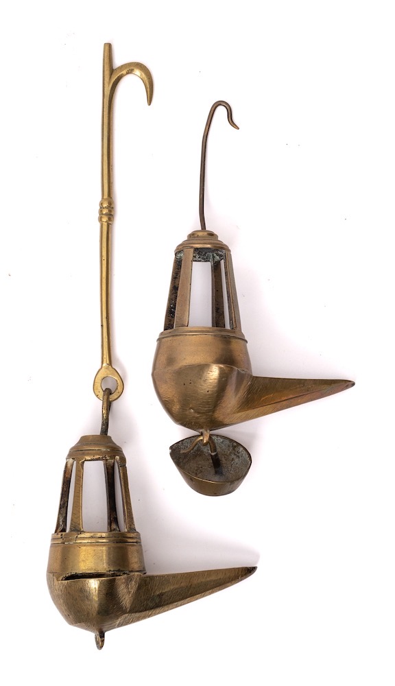Two 18th Century brass Crusie lamps: with suspension rods, pointed oil wells and lantern surmounts,