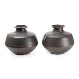 A pair of Rajasthan beaten copper water jars: of ovoid form with flared rims, on flattened bases,
