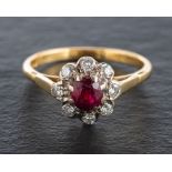 An 18ct gold, ruby and round, brilliant-cut diamond cluster ring,