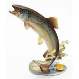 A German Hutschenreuther porcelain model of a Rainbow Trout: leaping above lily pads,