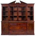 A mahogany and glazed breakfront library bookcase in George III style,