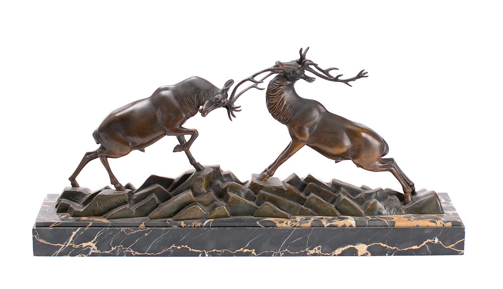 After Irenee Rochard (1906-1984) A bronze study of rutting stags on a rocky plinth,