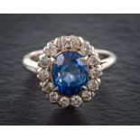 A 18ct white gold, synthetic sapphire and round brilliant-cut diamond cluster ring,