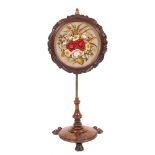 A George IV or William IV walnut pole screen, circa 1830,