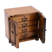 An Edwardian oak humidor in the form of a safe: with rectangular top and a pair of moulded panelled