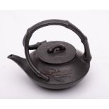 A small Yixing stoneware teapot and cover: of dark brown hue and of squat form with branching faux