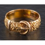 A Victorian 18ct gold buckle ring,: with engraved floral decoration, Birmingham, 1887, ring size P,